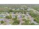 Aerial view of the neighborhood showcases mature landscaping, well-kept homes, and community tennis courts at 7058 Archwood Dr, Orlando, FL 32819