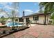 Beautiful backyard with a private pool, rock garden, open-air patio, and lounge chairs at 7058 Archwood Dr, Orlando, FL 32819