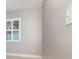 Window with white shutters letting light into the bedroom with grey walls and baseboards at 7058 Archwood Dr, Orlando, FL 32819