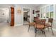 Bright breakfast nook with a round glass table and woven chairs near shuttered windows at 7058 Archwood Dr, Orlando, FL 32819