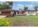Charming single-story home featuring a well-maintained front yard and a two-car garage at 7058 Archwood Dr, Orlando, FL 32819