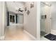 Bright hallway with tile floors, a ceiling fan, decorative wall art, and a modern glass-enclosed shower at 7058 Archwood Dr, Orlando, FL 32819