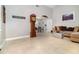 Spacious living room with neutral walls and floors, a grandfather clock, and comfortable seating at 7058 Archwood Dr, Orlando, FL 32819