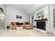 Cozy living room with a stone fireplace, comfortable seating, and neutral decor at 7058 Archwood Dr, Orlando, FL 32819
