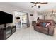 Comfortable living room featuring a brown recliner, ceiling fan, and sliding glass door to the patio at 7058 Archwood Dr, Orlando, FL 32819