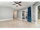 Spacious living room with tile floors, ceiling fan, and sliding glass doors, offering plenty of natural light at 7058 Archwood Dr, Orlando, FL 32819
