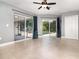 Open-concept living area featuring tile flooring, ceiling fan, and sliding glass doors to the backyard pool at 7058 Archwood Dr, Orlando, FL 32819