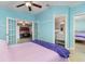 Main bedroom boasts blue accent walls with an en-suite bathroom and an adjacent bedroom with a shared door at 7058 Archwood Dr, Orlando, FL 32819