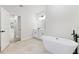 Spa-like bathroom featuring a soaking tub, modern vanity, and sleek fixtures at 706 Marion Oaks Manor, Ocala, FL 34473