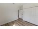 Bedroom with sleek hardwood flooring, closet, and doorway to other parts of the home at 706 Marion Oaks Manor, Ocala, FL 34473