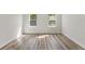 Sun-filled bedroom with hardwood floors, neutral walls, and large windows overlooking the backyard at 706 Marion Oaks Manor, Ocala, FL 34473