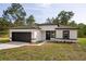 Charming single-story home featuring a two-car garage and freshly landscaped front yard at 706 Marion Oaks Manor, Ocala, FL 34473