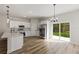 Bright kitchen with stainless steel appliances, quartz countertops, and sliding glass doors to the backyard at 706 Marion Oaks Manor, Ocala, FL 34473