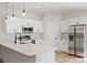 Contemporary kitchen showcasing white cabinetry, stainless steel appliances and quartz countertops at 706 Marion Oaks Manor, Ocala, FL 34473