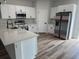 Bright kitchen with white cabinetry, stainless steel appliances, and a quartz countertop at 706 Marion Oaks Manor, Ocala, FL 34473