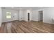 Spacious living room showcasing wood-look flooring, neutral paint colors, and ample natural light at 706 Marion Oaks Manor, Ocala, FL 34473