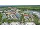 Beautiful aerial view of town center featuring colorful buildings, parking, green space, and a lake at 720 Celebration Ave # 245, Kissimmee, FL 34747