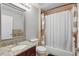 Cozy bathroom with a shower-tub combination, granite vanity and mirror, offering functionality and comfort at 720 Celebration Ave # 245, Kissimmee, FL 34747