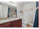 Bathroom featuring double sinks, granite counters, and tiled walk-in shower at 720 Celebration Ave # 245, Kissimmee, FL 34747