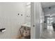 Cozy half bathroom featuring a unique vanity, decorative mirror, and white accent wall at 720 Celebration Ave # 245, Kissimmee, FL 34747