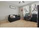 Bedroom showcasing neutral walls, a sofa, and a ceiling fan, with natural light streaming in through the windows at 720 Celebration Ave # 245, Kissimmee, FL 34747