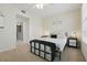 Bedroom with a ceiling fan, soft carpet, and view to a shared hallway at 720 Celebration Ave # 245, Kissimmee, FL 34747
