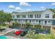 Building exterior showcasing balconies and well-maintained landscaping, complete with ample parking at 720 Celebration Ave # 245, Kissimmee, FL 34747