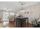 Bright dining area with a modern chandelier, dark wood floors, and seating for four at 720 Celebration Ave # 245, Kissimmee, FL 34747