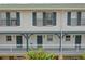 Charming two-story condo featuring a lovely porch and blue trim on the windows and supports at 720 Celebration Ave # 245, Kissimmee, FL 34747