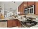 Functional kitchen boasting granite countertops, stainless steel appliances, and dark wood cabinets at 720 Celebration Ave # 245, Kissimmee, FL 34747