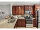 Well-equipped kitchen featuring granite countertops, stainless steel appliances, and abundant cabinet space at 720 Celebration Ave # 245, Kissimmee, FL 34747
