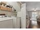 Convenient laundry room with washer, dryer and shelving for storage at 720 Celebration Ave # 245, Kissimmee, FL 34747