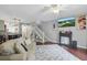 Comfortable living room includes fireplace, TV, staircase, and open floor plan to dining area at 720 Celebration Ave # 245, Kissimmee, FL 34747