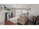 Spacious living room with dark wood floors, a cozy sofa, fireplace, and natural light at 720 Celebration Ave # 245, Kissimmee, FL 34747