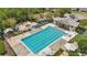 Community pool with multiple lanes, a hot tub and surrounding amenities in a lush outdoor setting at 720 Celebration Ave # 245, Kissimmee, FL 34747