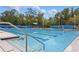 Community pool featuring multiple lanes for swimming and sunbathing, surrounded by lush landscaping at 720 Celebration Ave # 245, Kissimmee, FL 34747