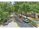 Scenic street lined with lush trees, storefronts, and parked cars, exuding charm and convenience at 720 Celebration Ave # 245, Kissimmee, FL 34747