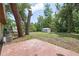 Spacious backyard featuring a utility shed surrounded by mature trees providing ample shade at 881 Cedar Cir, Tavares, FL 32778