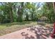 Spacious backyard featuring mature trees, a trampoline, and partial views of a shed at 881 Cedar Cir, Tavares, FL 32778