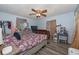 Cozy bedroom with ceiling fan, storage dresser, and closet space at 881 Cedar Cir, Tavares, FL 32778