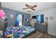 Bedroom with ceiling fan, dresser, and blue décor at 881 Cedar Cir, Tavares, FL 32778