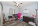 Bedroom with ceiling fan, closet space, computer desk, and storage area at 881 Cedar Cir, Tavares, FL 32778