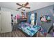 Comfortable bedroom with ceiling fan, laminate flooring, and a full-size bed at 881 Cedar Cir, Tavares, FL 32778