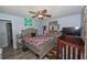 Comfortable bedroom with ceiling fan, queen bed, and storage area at 881 Cedar Cir, Tavares, FL 32778