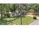 Aerial view of home featuring front yard and brick exterior details at 881 Cedar Cir, Tavares, FL 32778