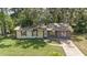 Lovely single-story home featuring a well-manicured lawn and lush landscaping at 881 Cedar Cir, Tavares, FL 32778