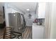 Open kitchen with stainless steel refrigerator and light-filled ambiance at 881 Cedar Cir, Tavares, FL 32778