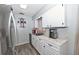 Well-lit kitchen featuring white cabinets and countertops, with stainless steel appliances at 881 Cedar Cir, Tavares, FL 32778