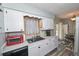 Kitchen featuring white cabinets, stainless sink and modern countertop appliances at 881 Cedar Cir, Tavares, FL 32778