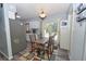 Cozy dining area in the kitchen featuring modern appliances and a door to the backyard at 881 Cedar Cir, Tavares, FL 32778